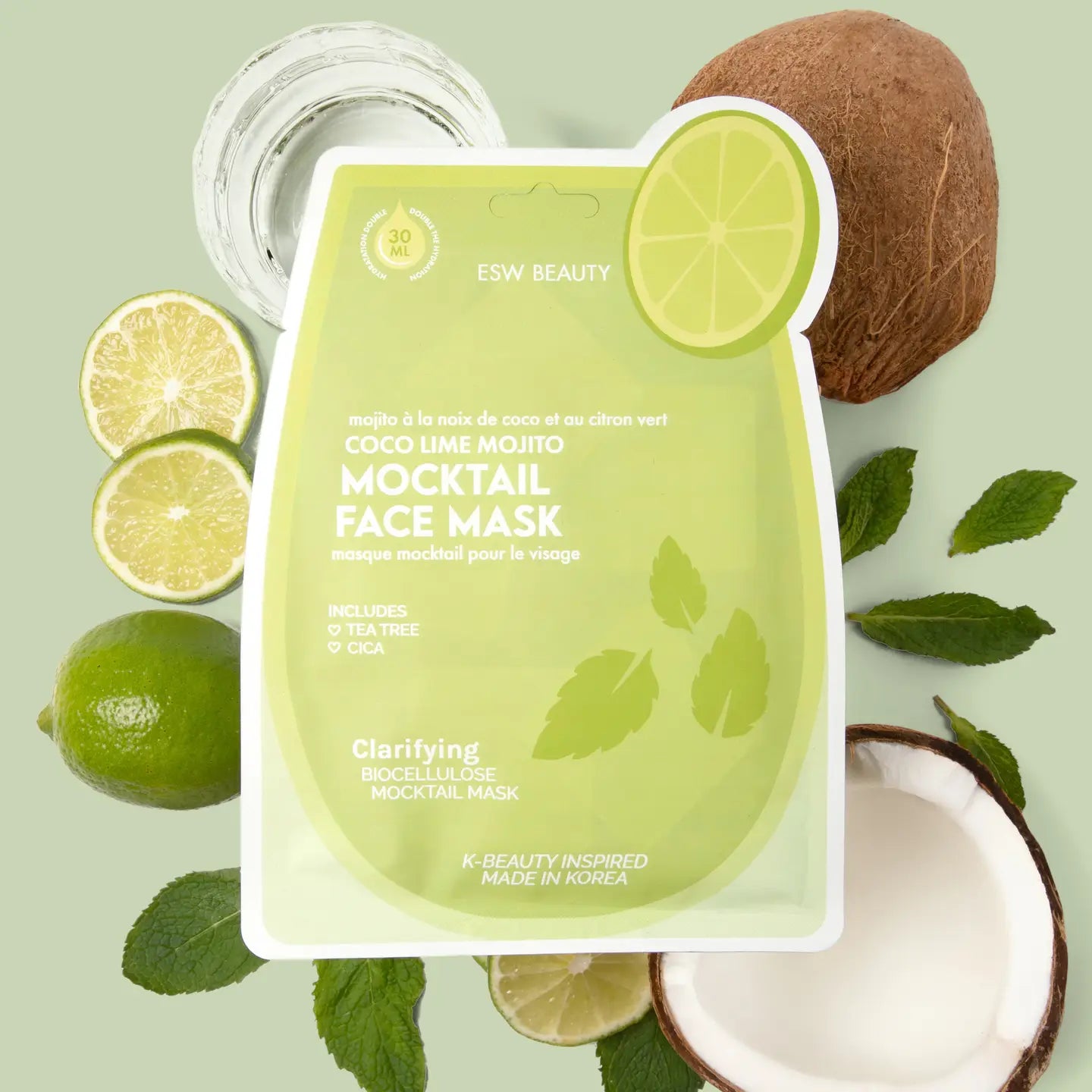 Coconut lime mojito mocktail face mask with limes and coconuts on a light green background
