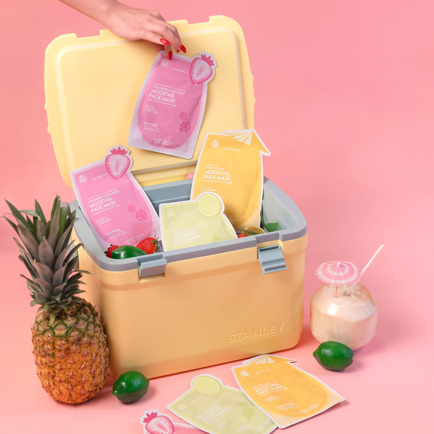 Yellow cooler with skincare masks on a pink background
