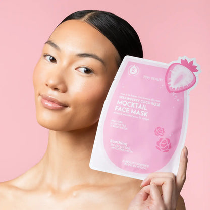 Woman holding a pink face mask package against a pink background